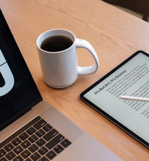 a tablet and a cup of coffee on a table