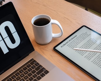 a tablet and a cup of coffee on a table