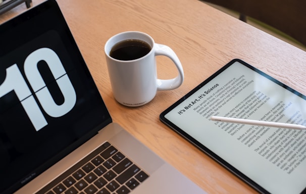 a tablet and a cup of coffee on a table