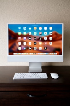 a desktop computer sitting on top of a wooden desk