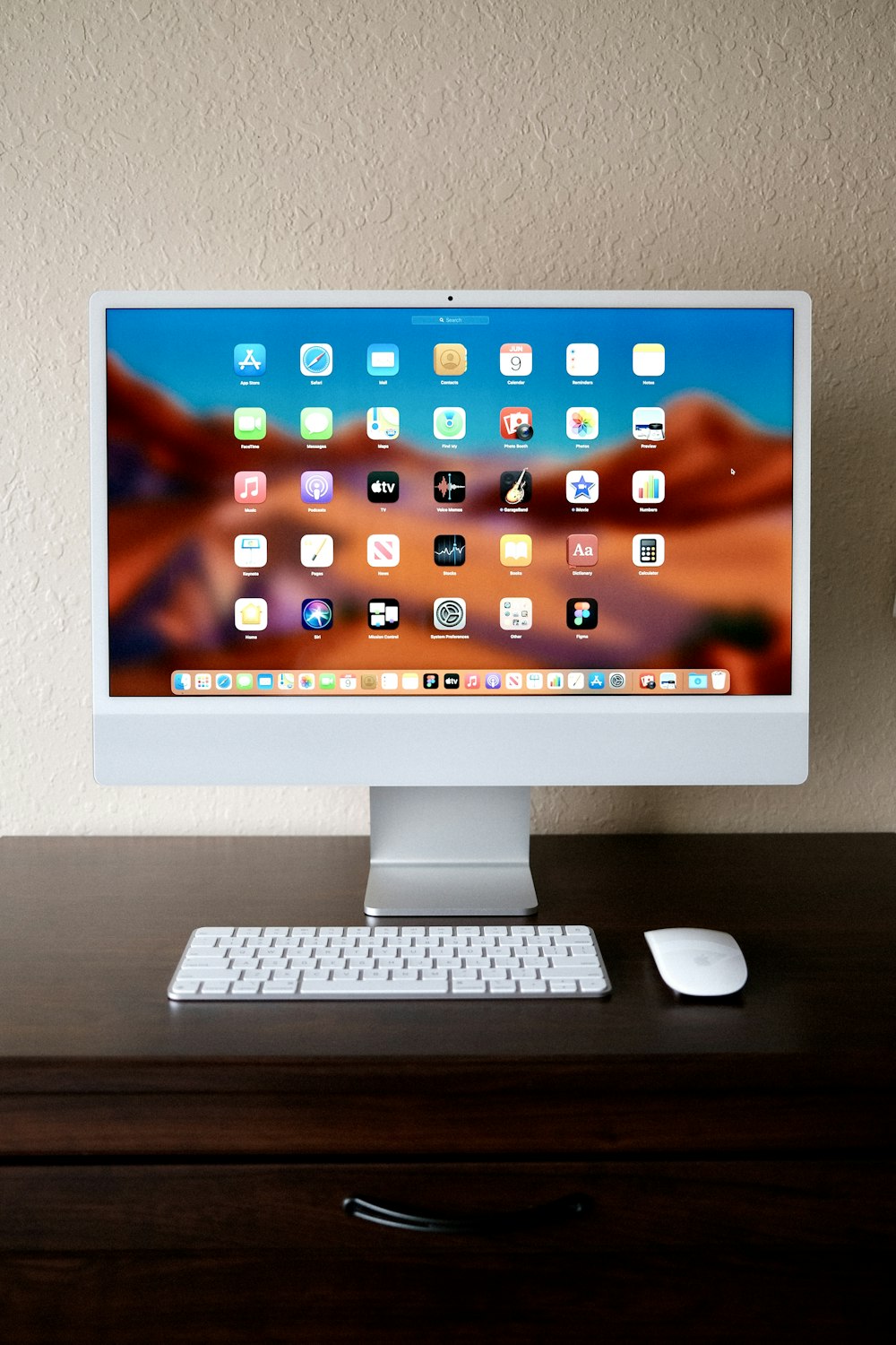 a desktop computer sitting on top of a wooden desk