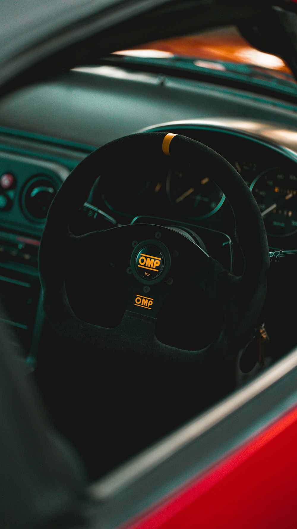 the interior of a car with a steering wheel and dashboard