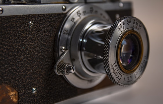 A close-up photograph capturing intricate textures and natural light on a vintage camera lens.