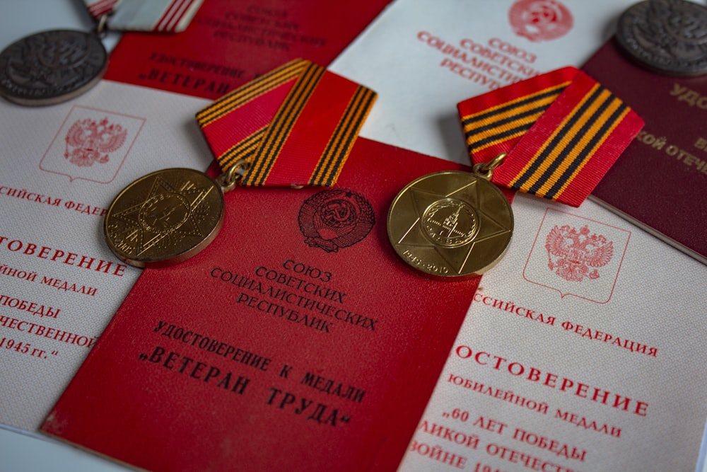 a couple of medals sitting on top of a red card