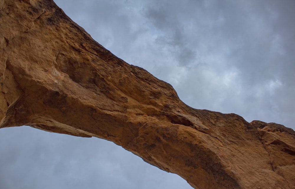 a large rock formation with a sky in the background