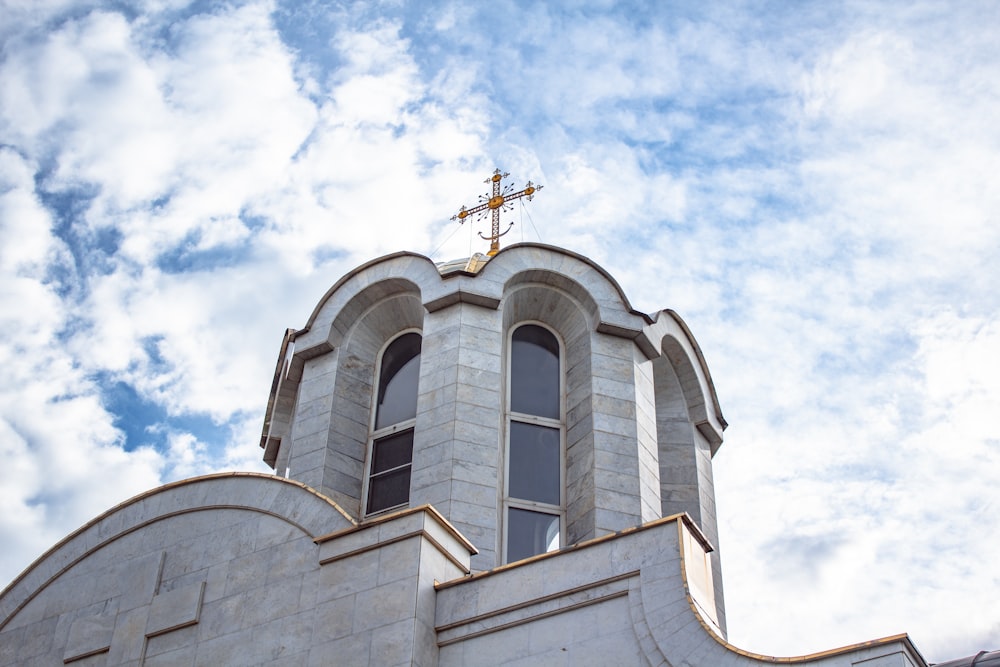 a church steeple with a cross on top