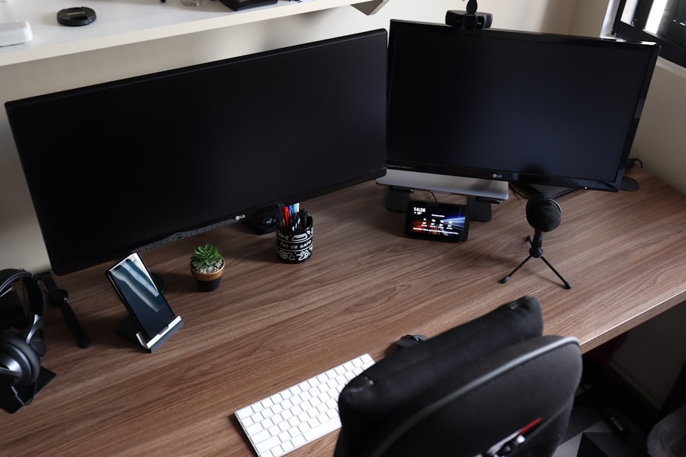 a computer desk with two monitors and a keyboard