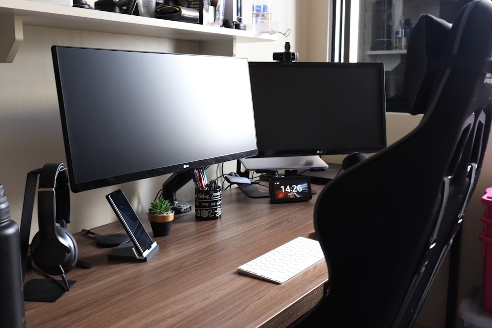 a computer desk with a monitor and keyboard