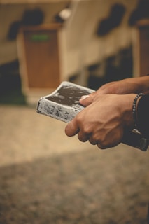 a person holding a cell phone in their hand