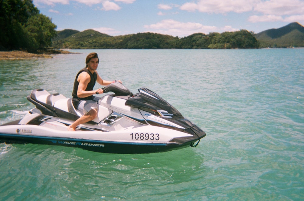 a man riding a jet ski across a lake