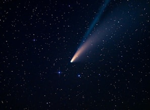 a comet is seen in the night sky