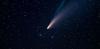 a comet is seen in the night sky