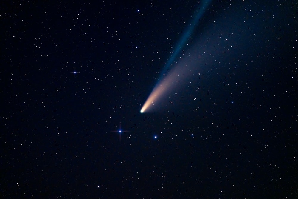 a comet is seen in the night sky