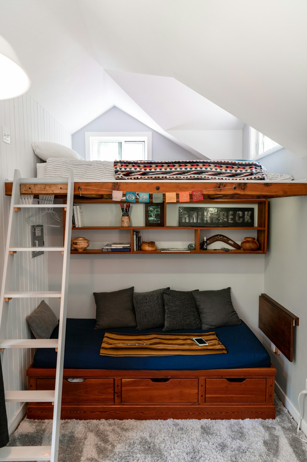 a loft bed with a ladder to the top of it