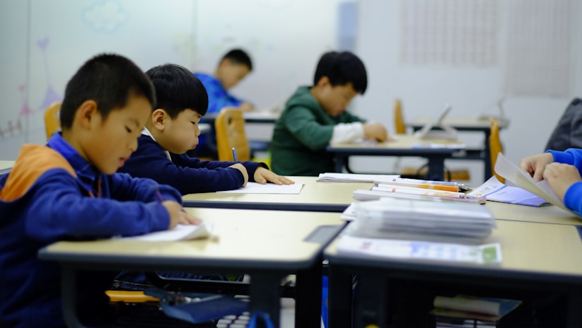 a group of children sitting at desks in a classroom