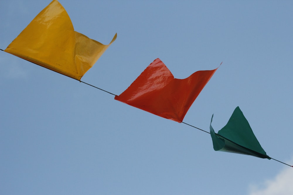 three kites are flying in the sky together