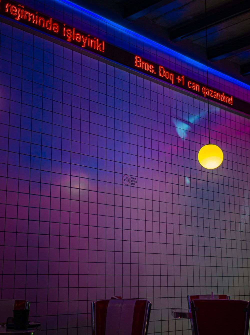 a purple and blue tiled wall in a restaurant