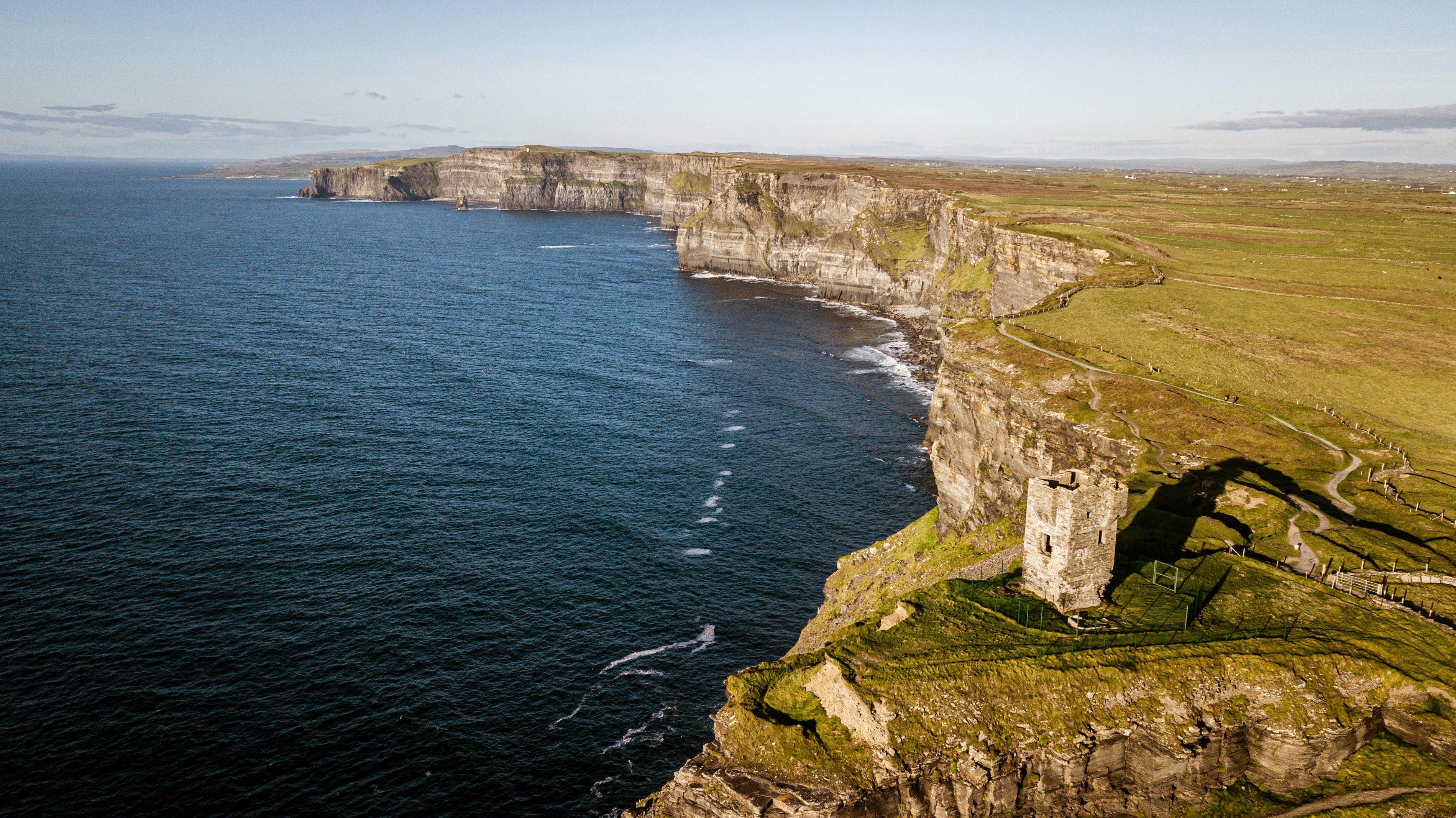 an aerial view of a cliff with a large body of water