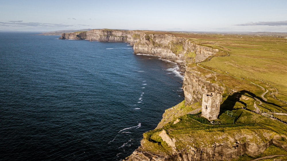 an aerial view of a cliff with a large body of water