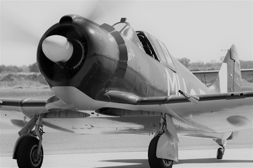 a black and white photo of a propeller plane