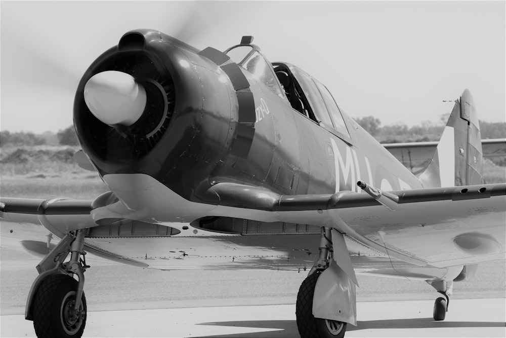 a black and white photo of a propeller plane