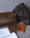 The image features two leather pouches, one dark brown and one black, positioned on a fabric surface. In front of them are two leather wallets, one brown and the other tan, along with a branded white cloth bag labeled 'blackduck'. The items appear to be high-quality leather goods.