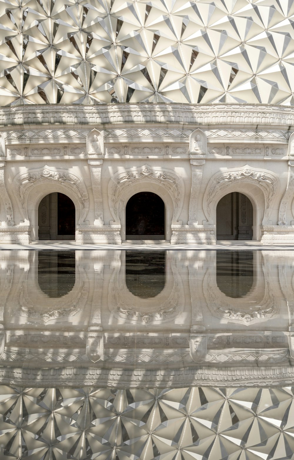 a reflection of a building in a pool of water