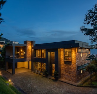 a house with a lot of windows lit up at night