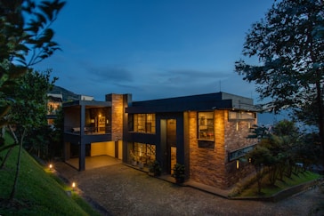 a house with a lot of windows lit up at night