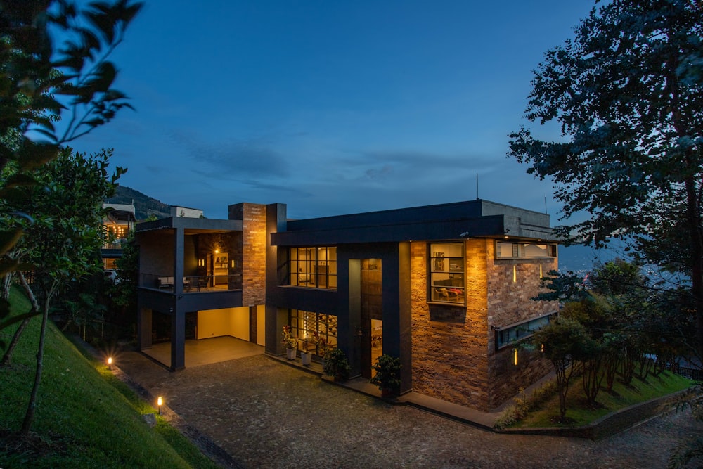 a house with a lot of windows lit up at night