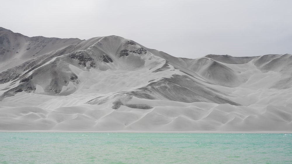 a mountain range with a body of water in front of it