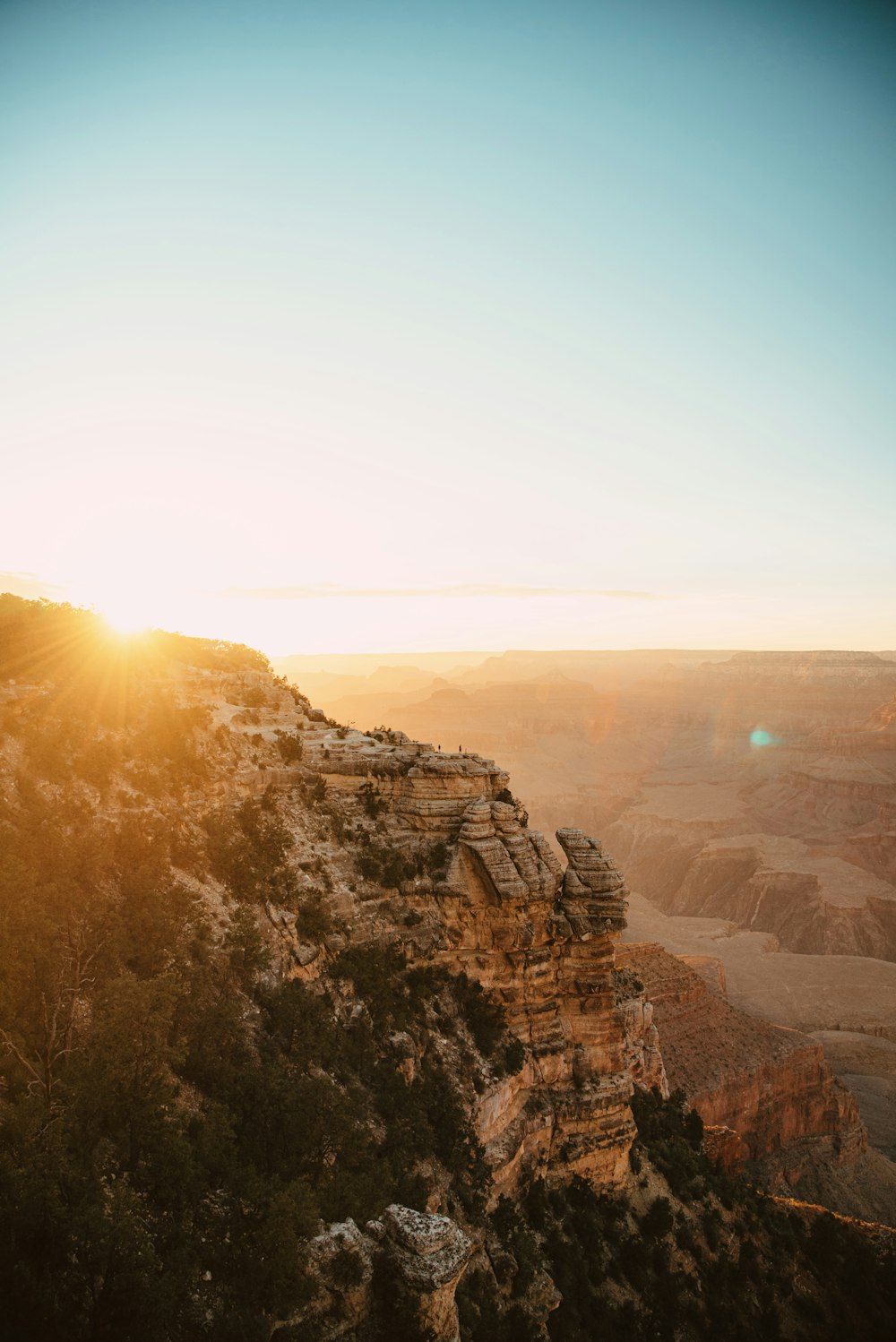 the sun is setting over the canyons in the desert