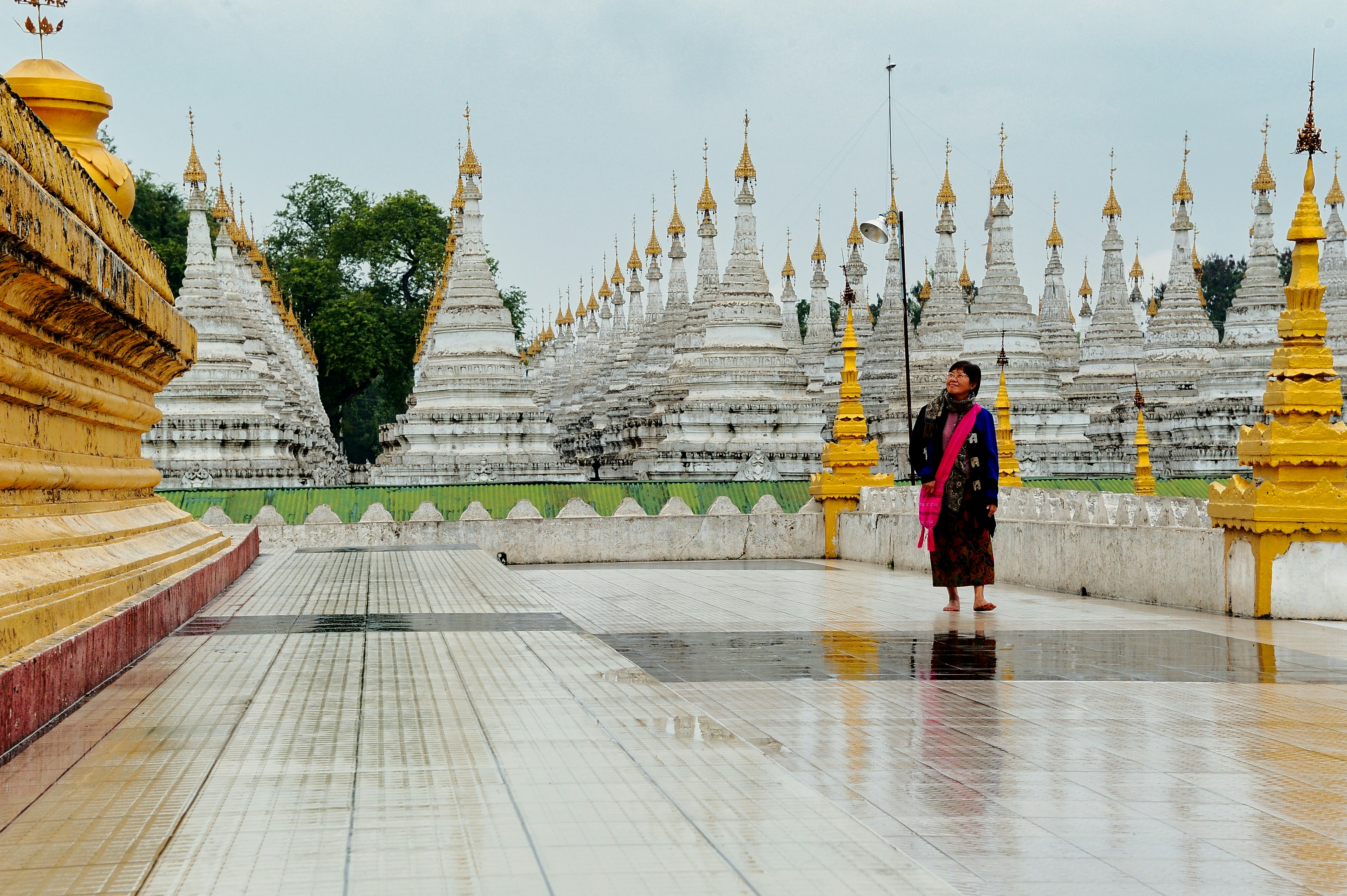 woman in black and red dress standing on white and brown concrete floor, 