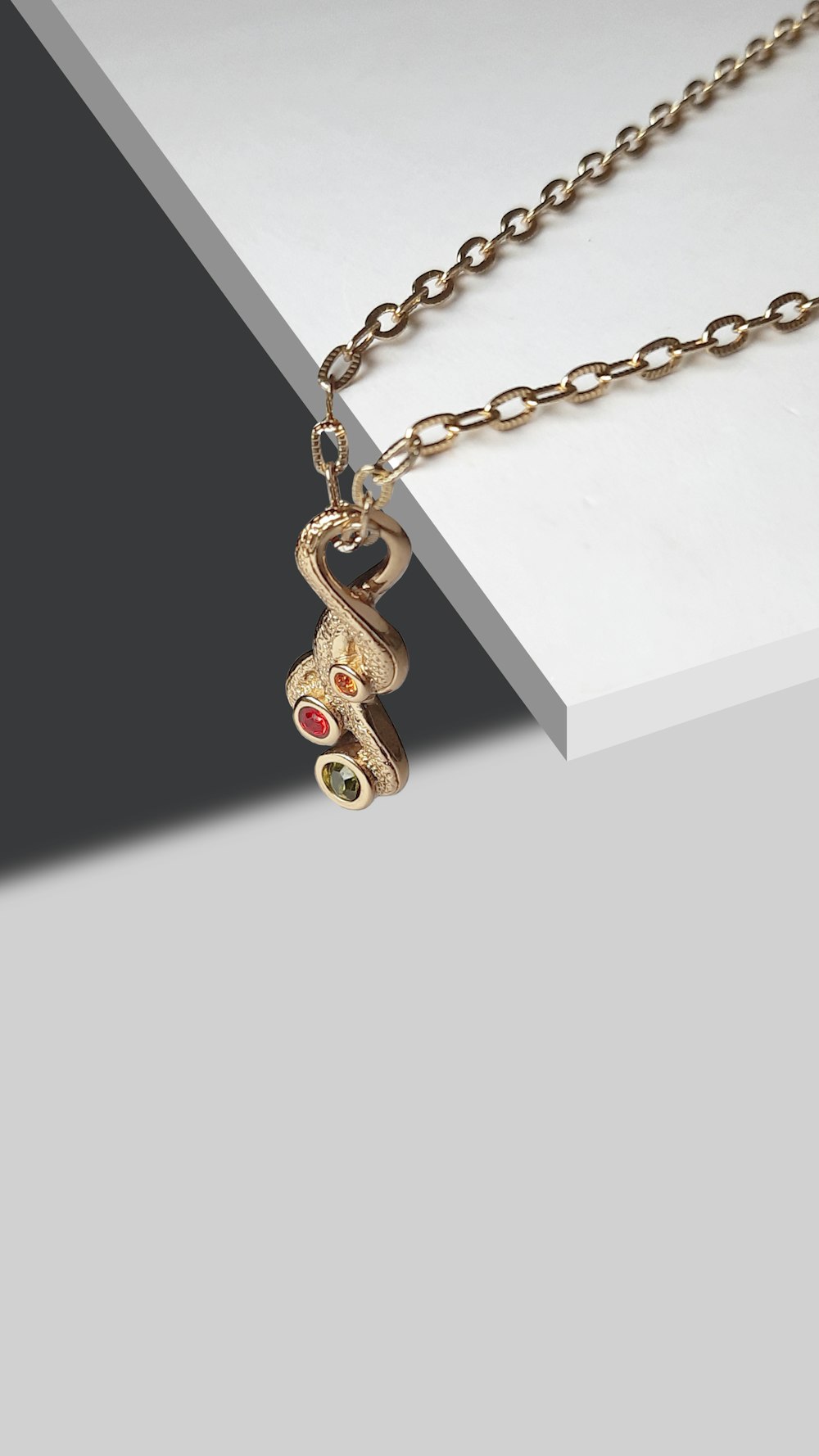 a gold necklace with a teddy bear on it