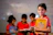 boy in red crew neck shirt holding yellow book