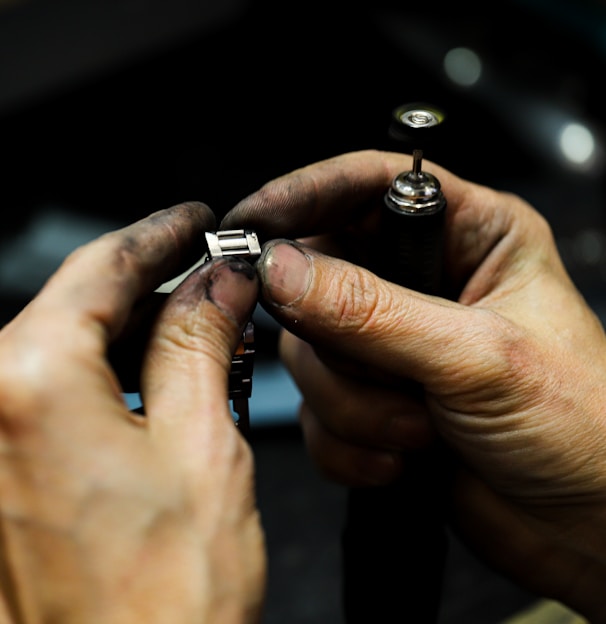 a man is working on a piece of metal