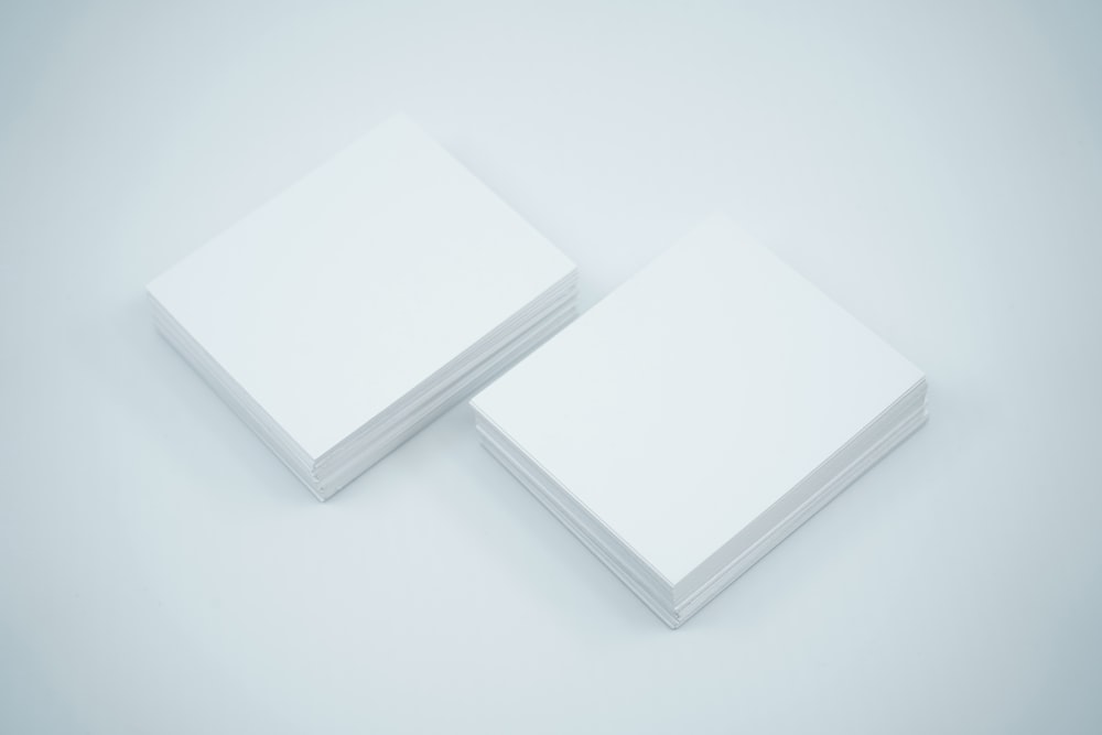 a couple of white cards sitting on top of each other