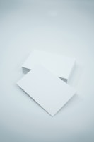 two blank paper sheets on a white background