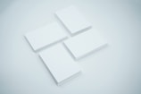 Stack of various credit cards spread out on a clean white surface.