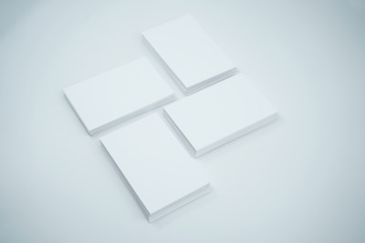 Stack of various credit cards spread out on a clean white surface.
