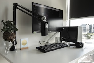 a desk with a computer monitor, keyboard and mouse