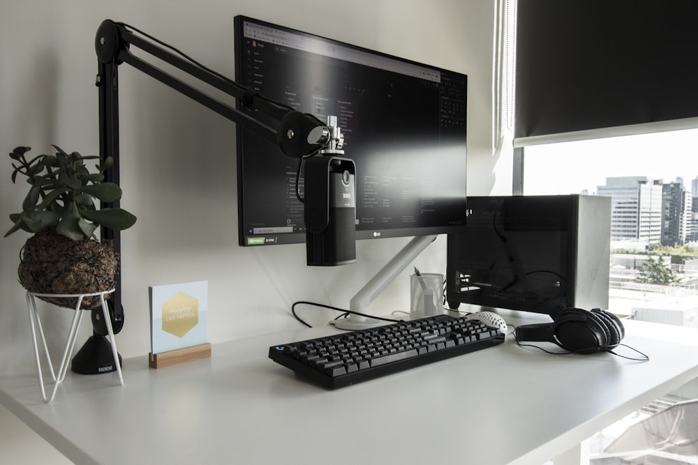 a desk with a computer monitor, keyboard and mouse