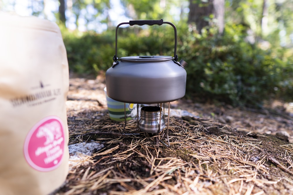 a gas can sitting on the ground next to a bag