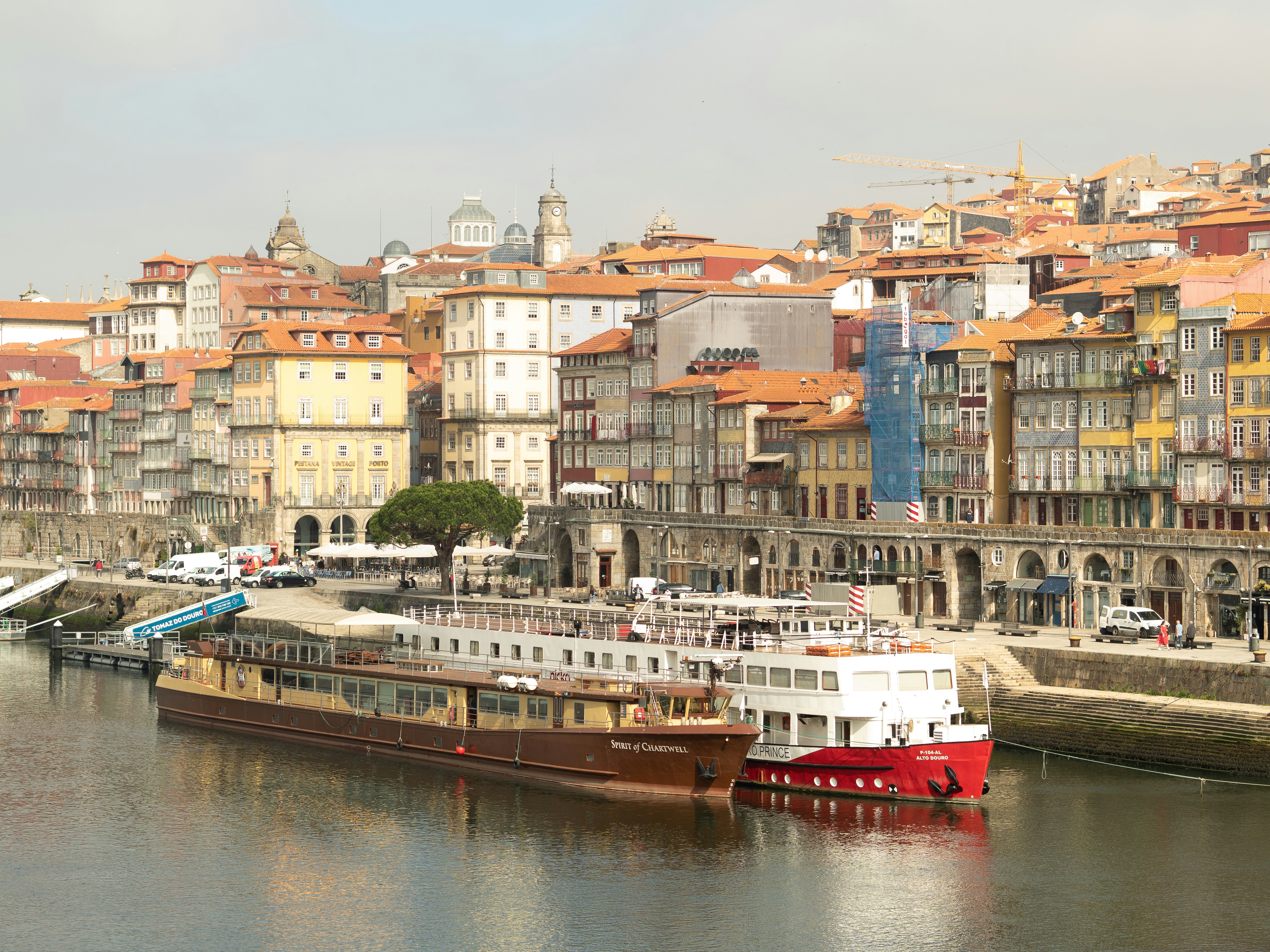 a boat is docked in the water next to a city