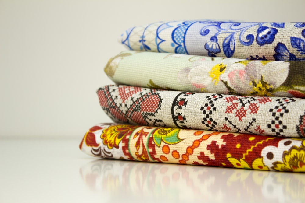 a stack of different colored fabrics sitting on top of each other