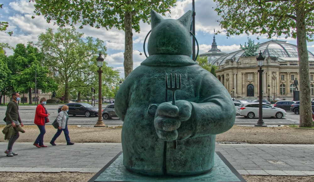 a statue of a man with a fork in his hand