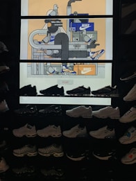 The image features a display of various Nike sneakers arranged on shelves. Above the sneakers is a vibrant, illustrated backdrop with expressive characters and Nike shoe boxes. The illustration depicts abstract figures and objects, incorporating geometric shapes and lines with a few cartoonish bird characters.