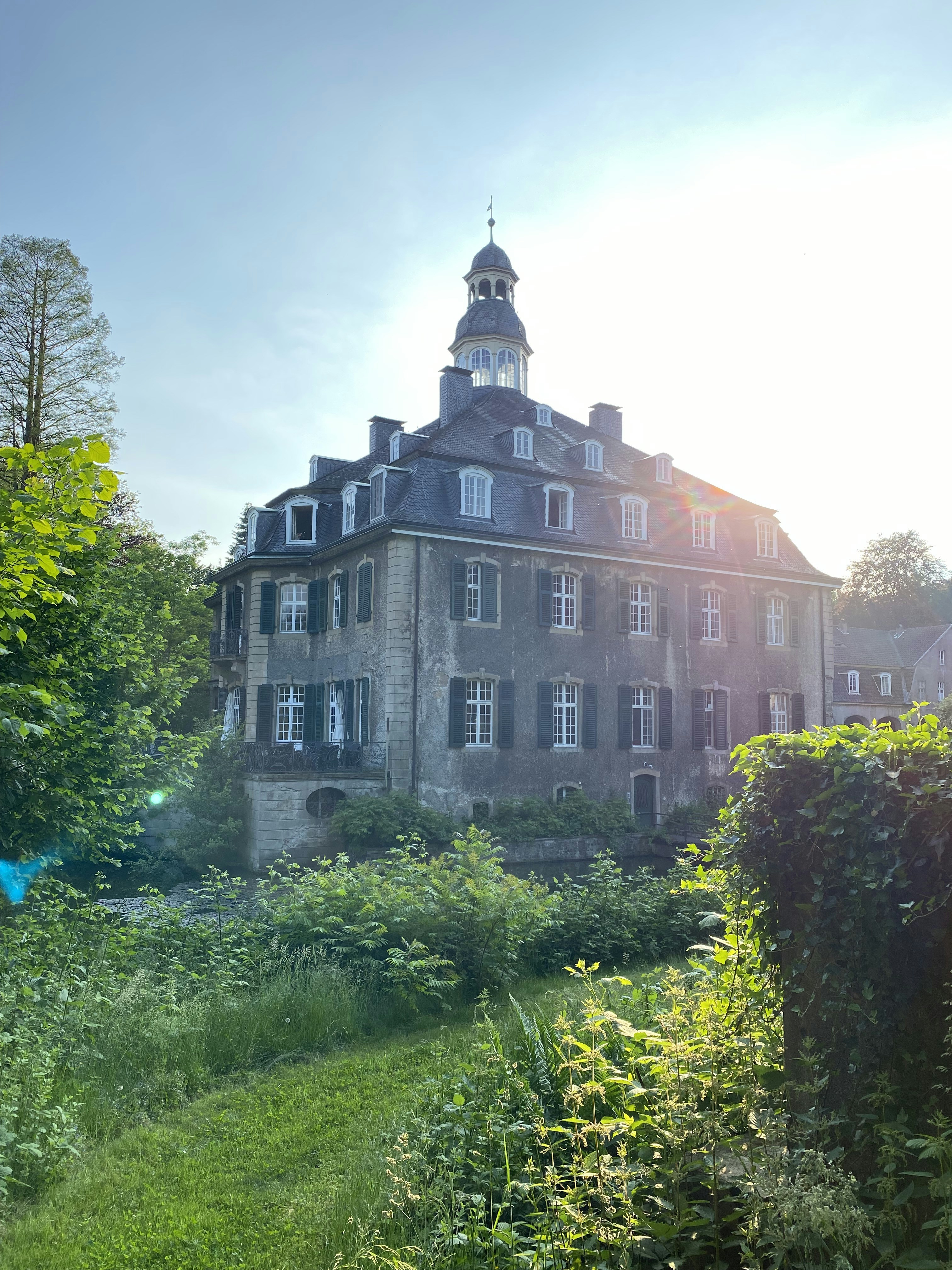 A large building with a clock tower on top of it photo – Free Plant ...