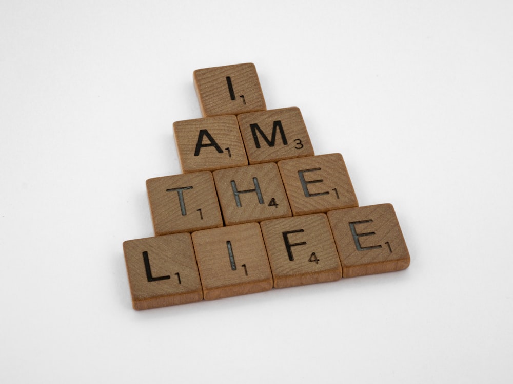a scrabbled wooden block that says i am the life
