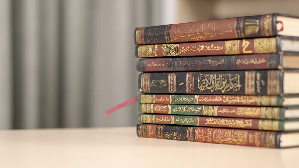 a stack of books sitting on top of a table